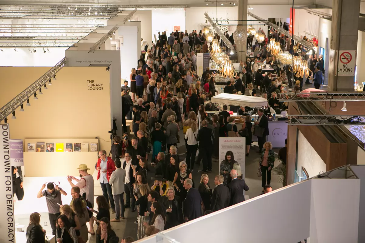 View over a large crowd of people in a gallery space.