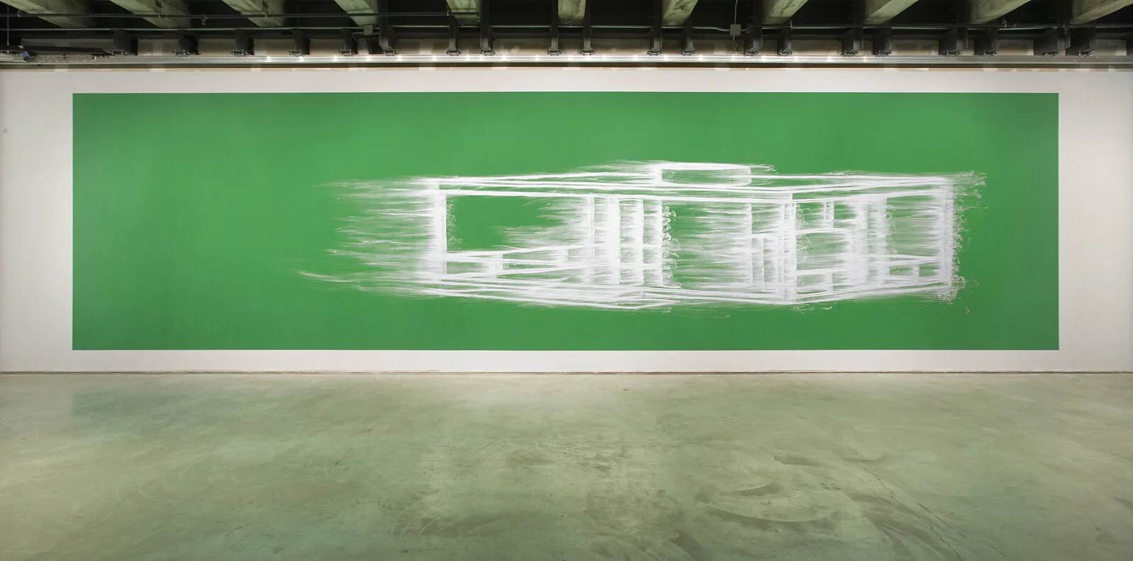 A wide green artwork featuring a smeared white line drawing hangs on a white wall in an industrial-style space.