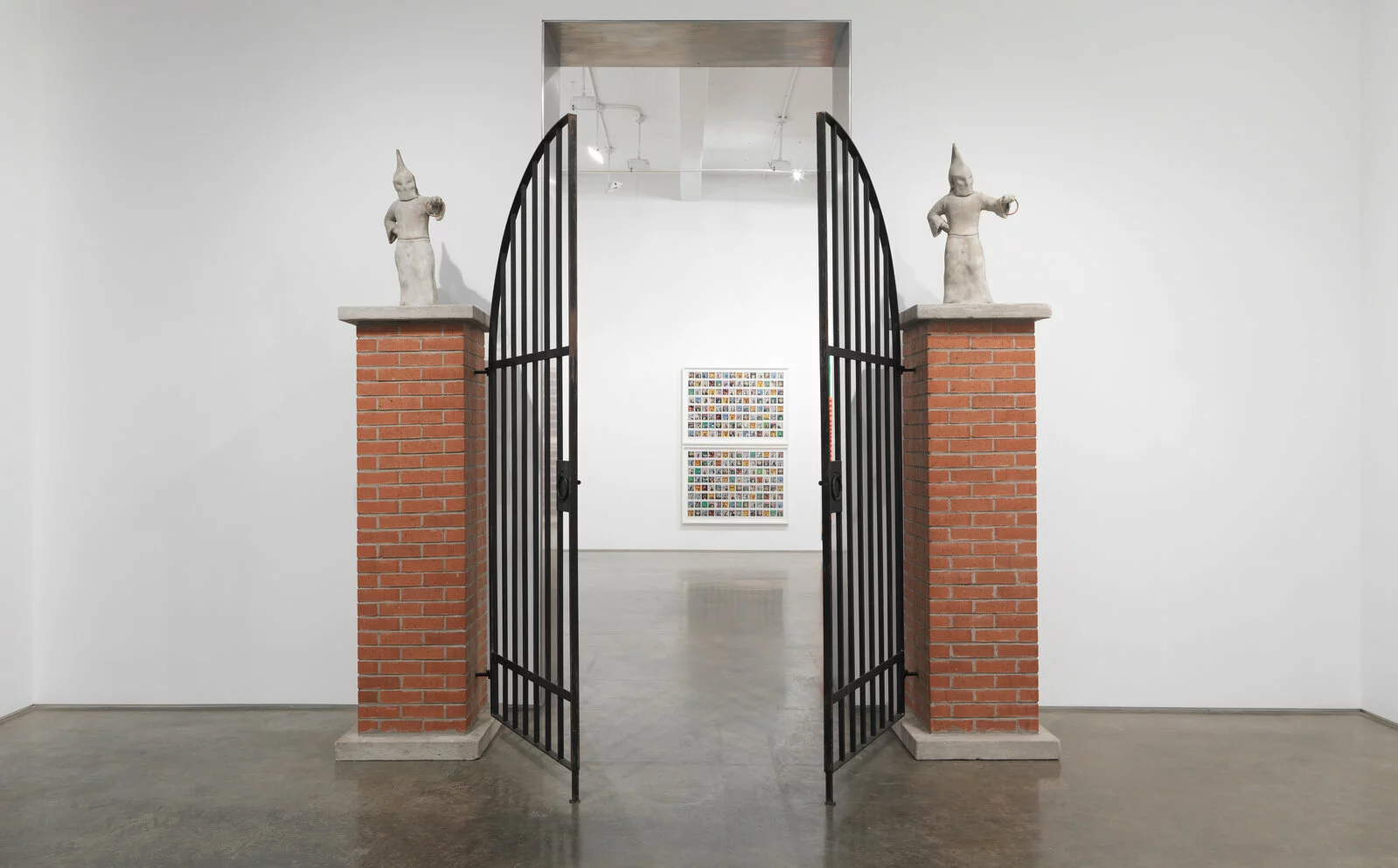 Gary Simmons, <em>Klan Gate</em>, 1992. Cast concrete, wood, brick, and steel; 120 × 114 × 25 1/2 in. (304.8 × 289.6 × 64.8 cm). Rubell Museum © Gary Simmons. 2022/11/Simmons-G_KlanGate-03.jpg 