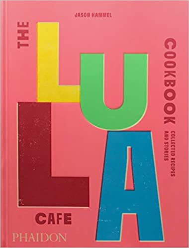 Pink book cover for The Lula Cafe Cookbook, with the letters of Lula staggered in different colors.