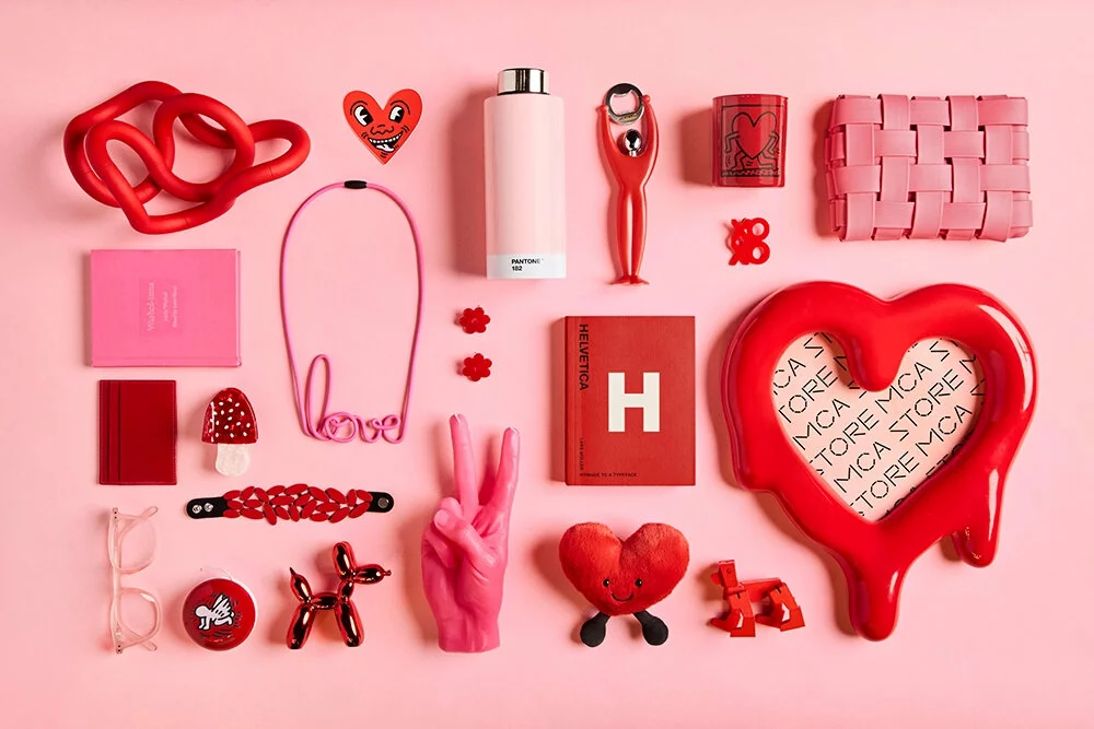 A variety of pink and red objects against a pink background.