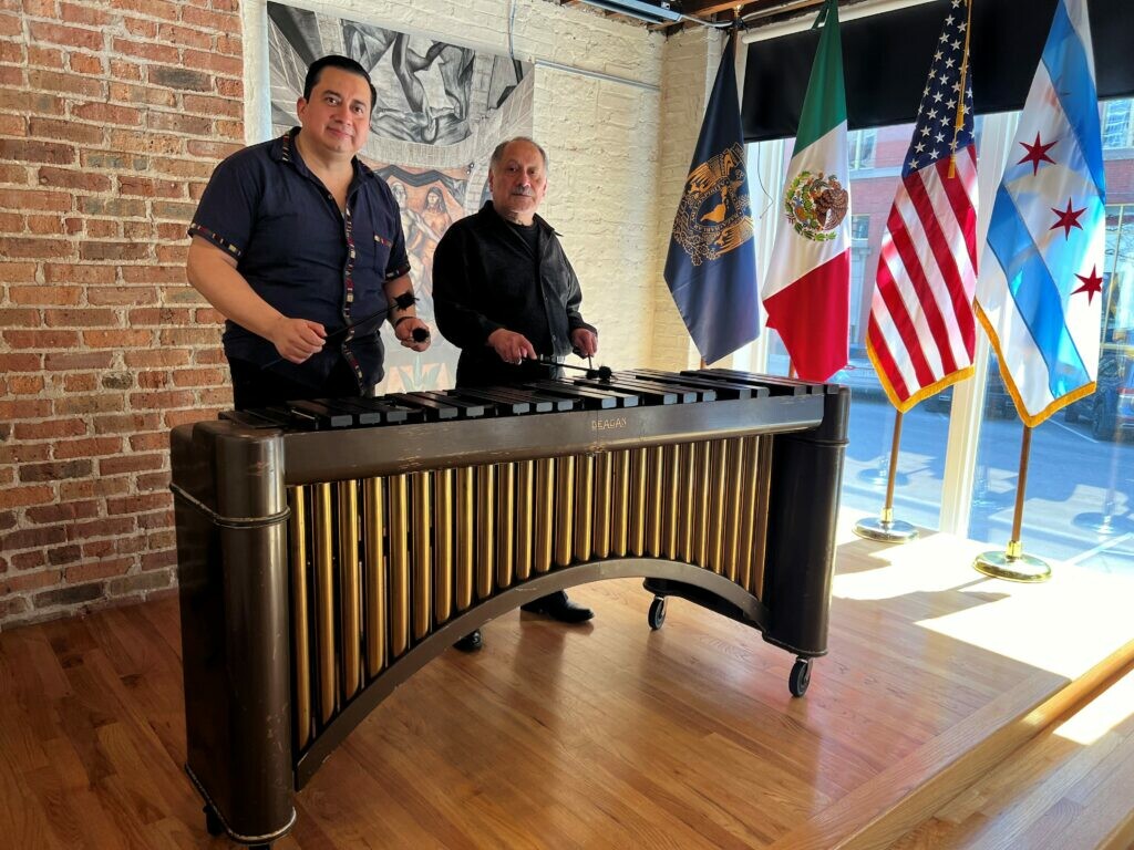 Two performers standing behind a marimba.