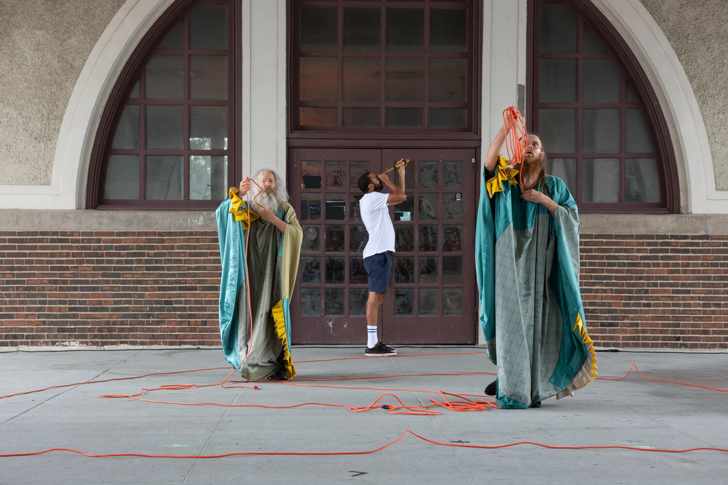 Performance still with three performers.