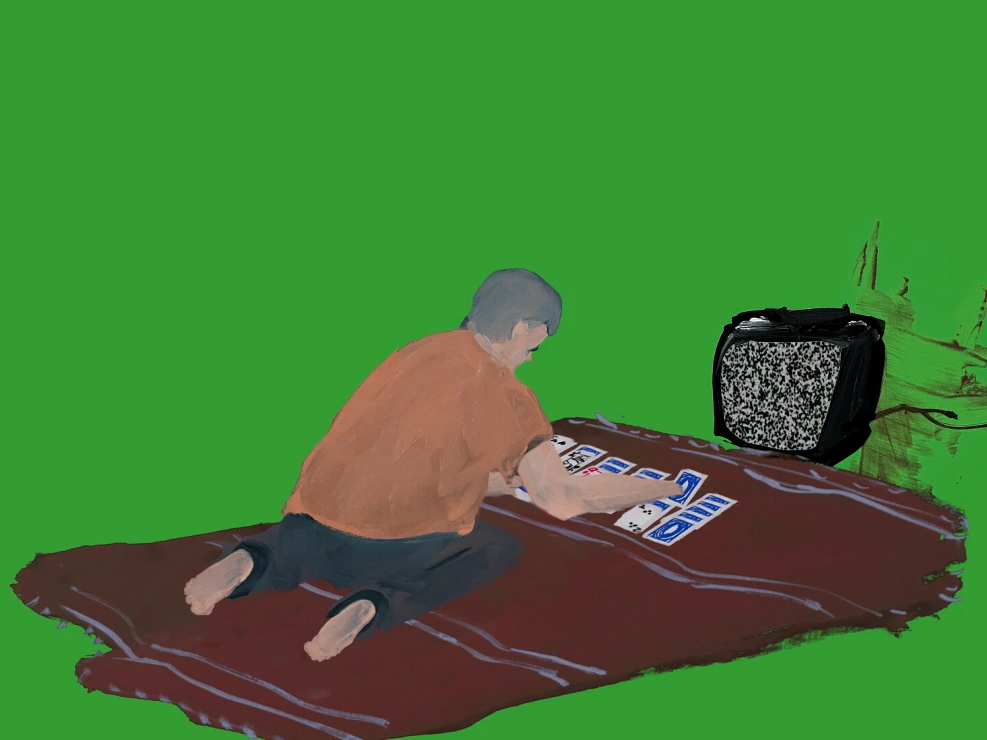Against a flat green background a person plays solitaire on a brown blanket in front of a tv displaying static