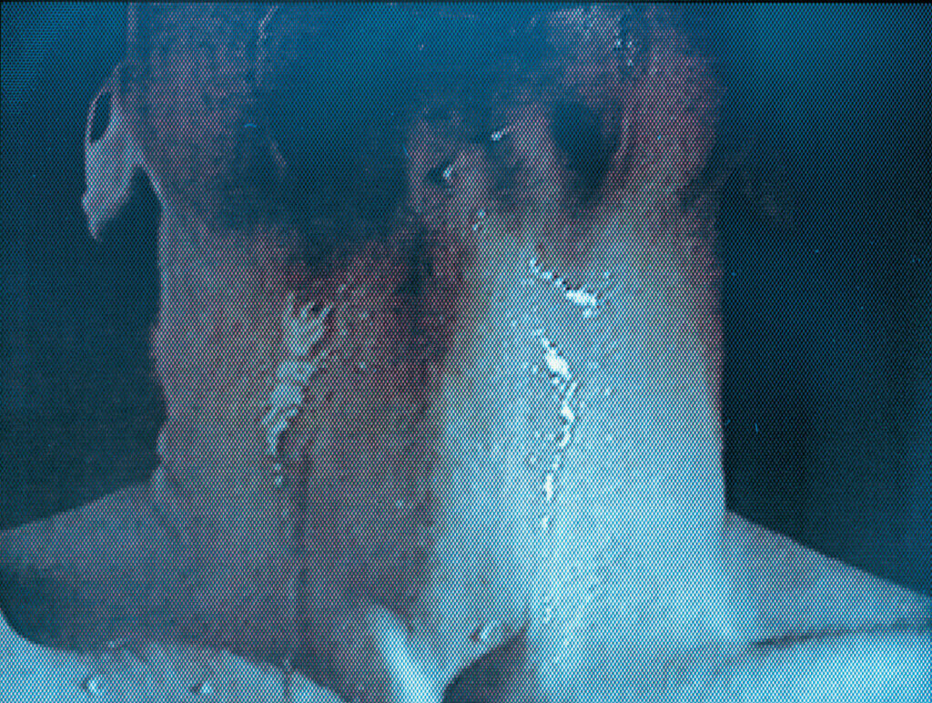 Closeup, grainy still of a neck with liquid running down it