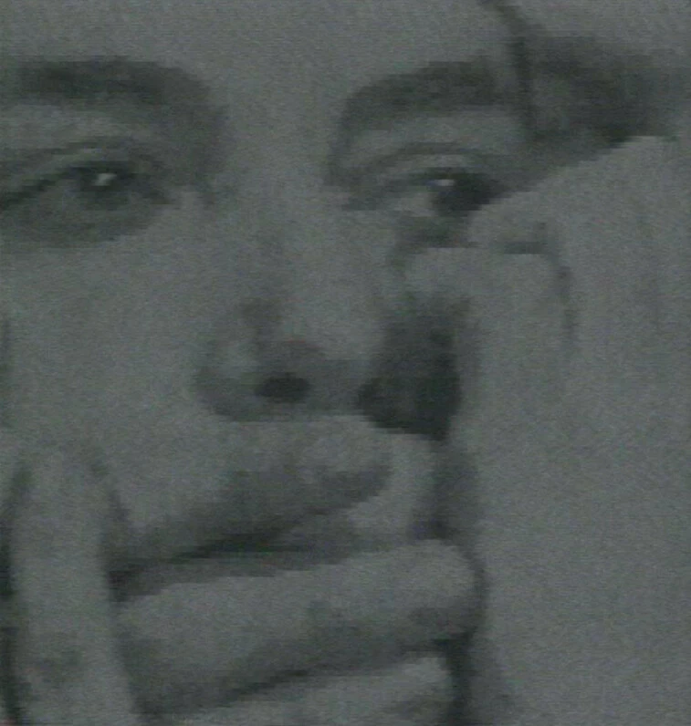 Closeup of a persons face with hands over and around their mouth