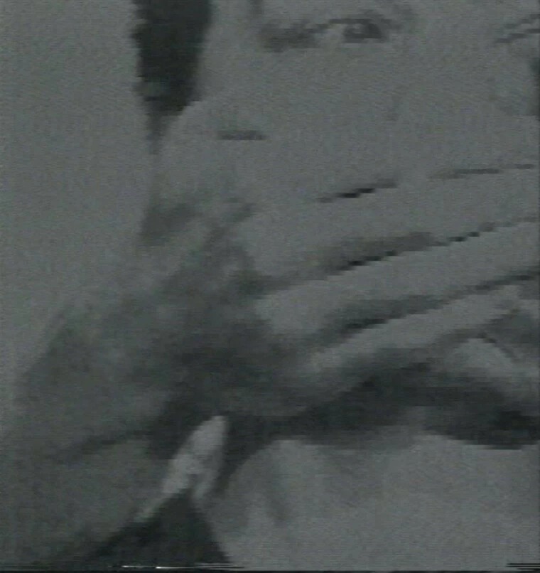 Closeup of a partial image of a person's face with two hands covering their mouth from behind.