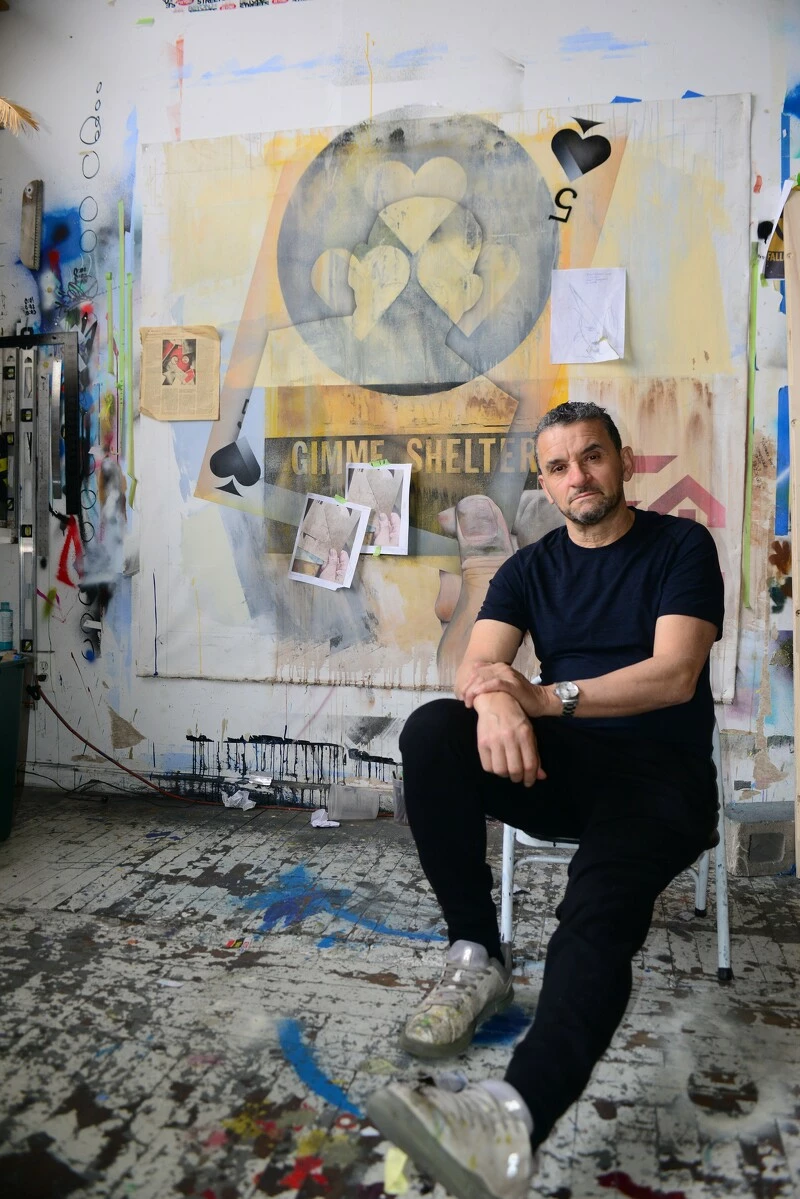 Portrait of a seated man in a studio setting