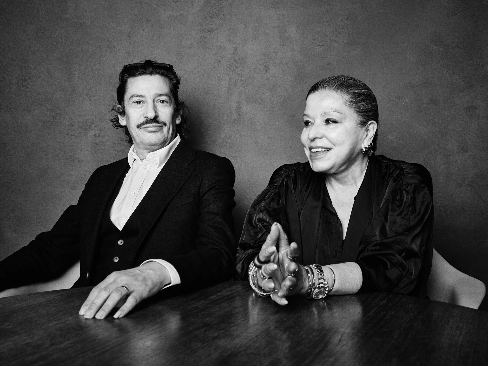 Black and white photo of two people sitting at a table