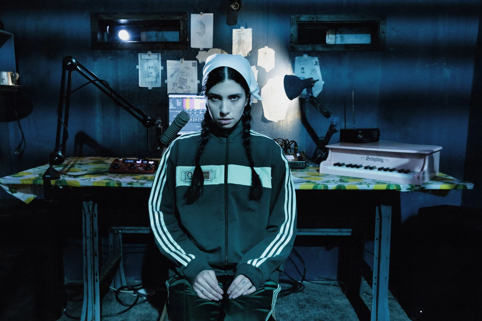 A person in ath-leisure sits in a blue-lit room