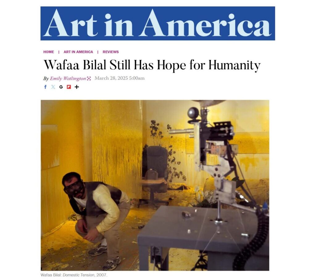 Screenshot of an Art in America article titled "Wafaa Bilal Still Has Hope for Humanity" featuring an image of a person crouching in front of a paintball gun machine